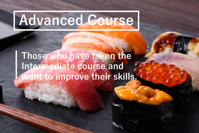 Advanced Course: an assortment of nigiri sushi on a slate board, including fatty tuna, salmon, prawn, sea urchin and salmon roe gunkan